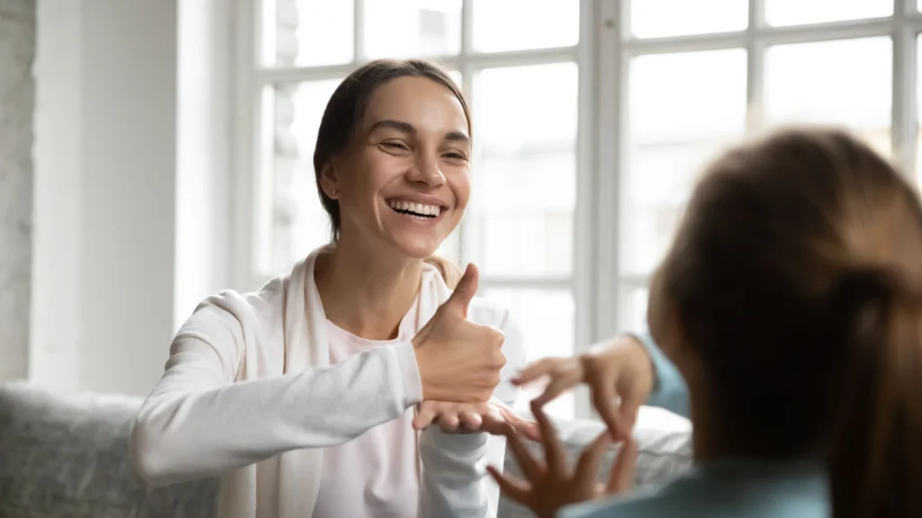 Woman signing to a deaf child