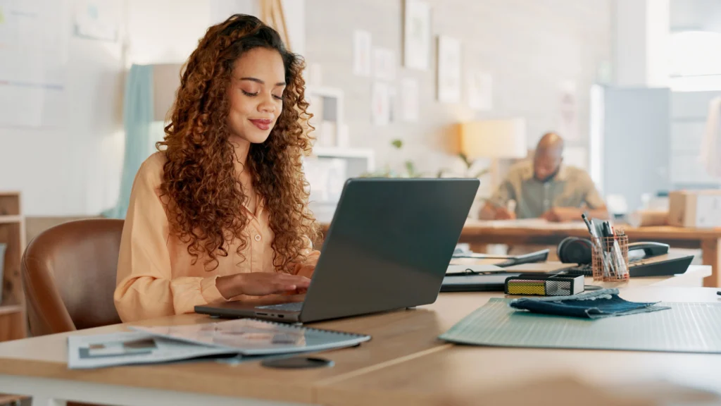 Woman sitting at her desk creating an email marketing campaign