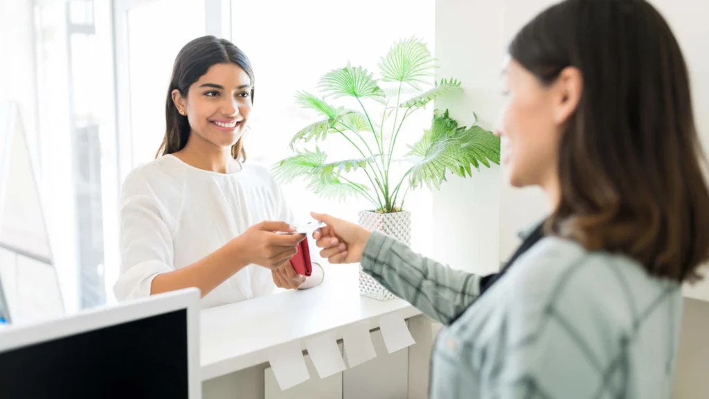 Woman at reception selling services to a female client